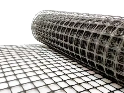 Close-up of plastic geogrid with square openings – locks soil particles in place to prevent sideways movement